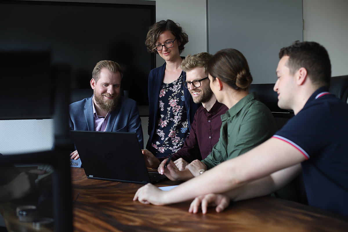 Mitarbeiterinnen und Mitarbeiter besprechen sich im Team